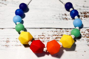 colorful rubber necklace children's toy on wooden background