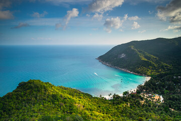 Thailand jungle island aerial: ocean sand beach at resort with lodges, homes, cottages at spring tropical forest. Green asian landscape at sea gulf Koh Tao Isle. Palm trees with bright greenery grass