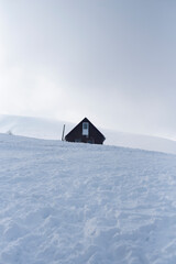 Cabin surrounded by snow and emptiness