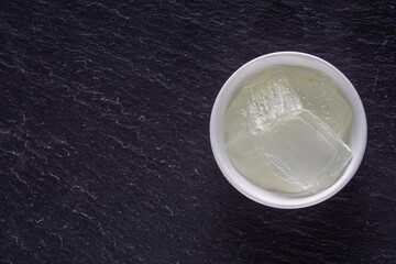 natural aloe vera cream on a dark stone background