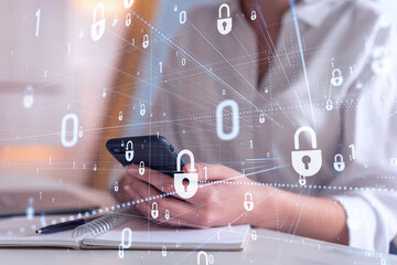A woman programmer is browsing the Internet in smart phone to protect a cyber security from hacker...