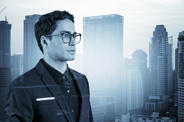 Young handsome businessman in suit and glasses dreaming about new career opportunities after MBA graduation. Bangkok on background. Double exposure.