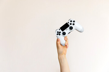 White video game joystick in hand on clean background.