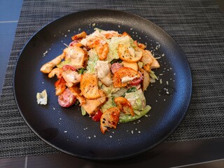 food on a plate caesar salad pasta with shrimp
