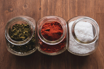 Obraz na płótnie Canvas Jars with spices on wooden table