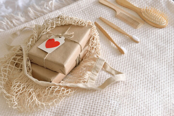 background with gift boxes decorated with paper heart in eco bag. Sustainable, eco friendly lifestyle concept. Set of Eco cosmetics products and tools. Selective focus. Valentines day, mother'day gift