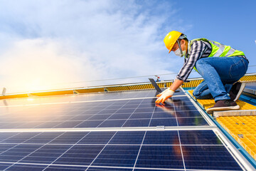 Engineers use a laptop computer to examine the solar panels at a power plant installed with solar panels using solar energy.
