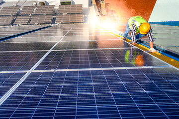 Engineers are examining solar panels in an installation at a power plant where solar panels are...