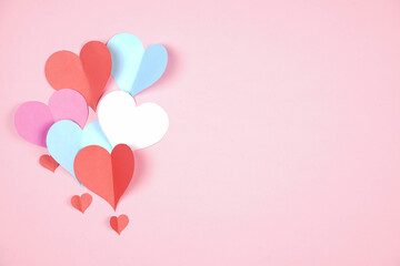 Fototapeta na wymiar Heart shaped paper sticked on pink background. Emblem of love for happy women, beloved mother, birthday cards and valentine greeting designs. Valentine's day backgrounds. Templates to convey our love.