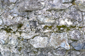 Old stone texture background. Nature mineral with mokh. Photo background with empty space. Grey, brown and green colors. Rock texture of mountains, grunge banner