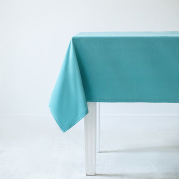 Blue decorative tablecloth on a table on a white background