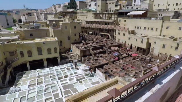 Men working at a leather tannery in Fez, Morocco