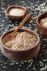 Set of different types of rice and cereals in wooden bowls and