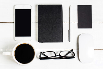 blank paperwork template designers responsive design mockup vintage wooden background paper letterhead coffee cup smartphone pencil headphones wooden table background top view (1)