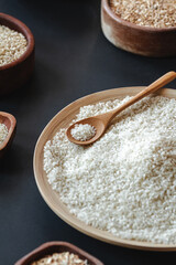 White round rice and cereals in wooden or bamboo spoon