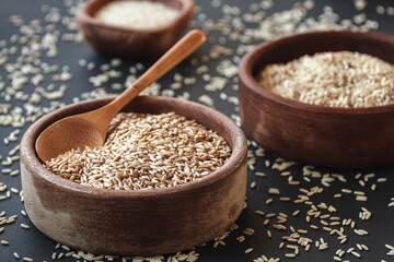 Set of different types of rice and cereals in wooden bowls and bamboo spoon