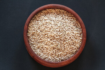 Brown rice in wooden bowl  top view