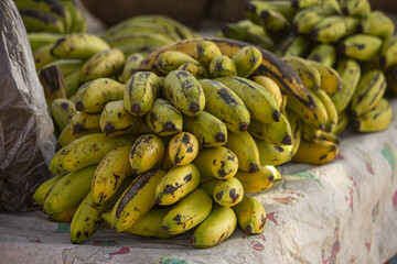 Heap of green plantains on a table © Juan Carlos Rodriguez Garcia/Wirestock