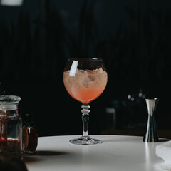 Cocktails with champagne in wine glasses on the bar table in the pub or restaurant with the bartender. 