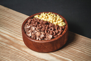 Wooden Bowl with different sorts of quick breakfast cereal products