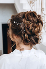 Beautiful bridal hairstyle with a hoop. Morning of the bride. Wedding preparations.