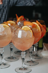 Cocktails with champagne in wine glasses on the bar table in the pub or restaurant with the bartender. 