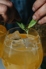 Cocktails with champagne in wine glasses on the bar table in the pub or restaurant with the bartender. 