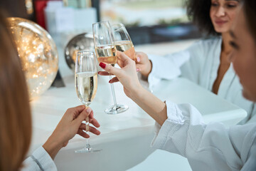 Three best female friends toasting with champagne
