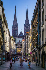 vibrant citylife in the rue des Gras with a view on the facade of the gothic cathedral of...