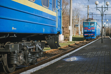 Truskavets, Ukraine - January 2021: Electric locomotive CHS7 with a freight train awaiting departure on the platform of the railway station. Ukrzaliznytsia. Ukrainian railways.