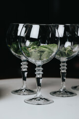 Cocktails with champagne in wine glasses on the bar table in the pub or restaurant with the bartender.