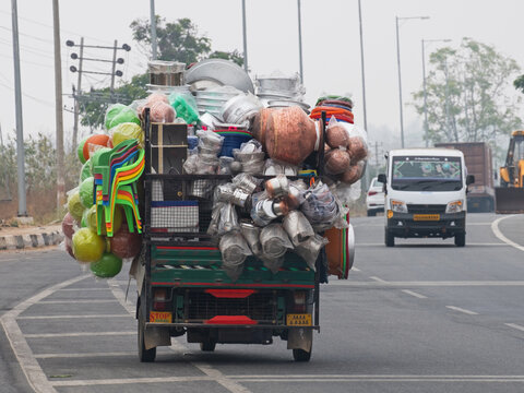Overloaded commercial vehicle carrying household goods on a main highway south of Mysore, India. Excessive loads are commonplace on Indian roads