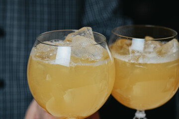 Cocktails with champagne in wine glasses on the bar table in the pub or restaurant with the bartender.