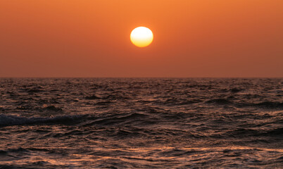 Orange sunset over the sea water surface
