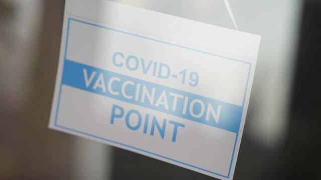 Information sign on the entrance to the Covid-19 Vaccination Center in 4K Slow motion 60fps