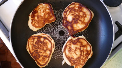 there are four small pancakes in the pan
