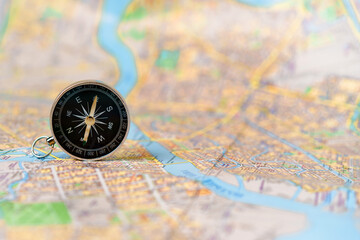 Compass standing vertically on the map of Saint Petersburg, concepts of travel, tourism and research, copyspace