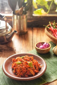 sambal cumi pete an indonesian sambal .salted squid with chilli and petai.on wooden table