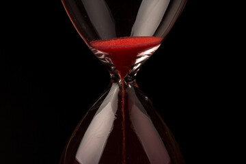 Crystal hourglass on black background as a concept of passing time for business term, urgency and...