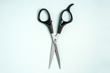 Hairdressing tools scissors lie on a blue background