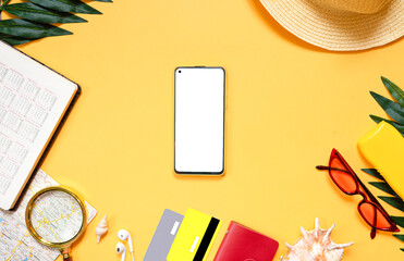 Smartphone with a set of accessories for sea travel and recreation, card, shell, glasses, headphones, bank cards, wallet, hat. Travel concept with a smartphone. Summer background. Flat lay. top view