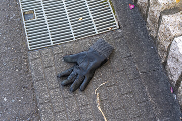 A glove left on a pavement, Japan