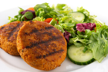 Delicious healthy chickpea burger and salad isolated on white background