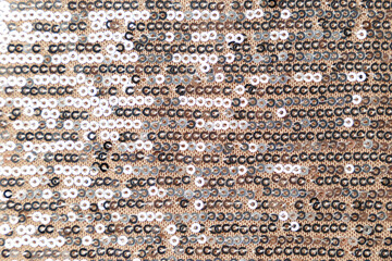 Polyester sequin fabric texture in gold and silver color. Luxury abstract background. Metal glitter silver cloth background. Close up. Trendy Metallic. Gray sequins, sparkling sequined textile