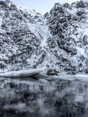 Winter landscape on a lake during Lofoten islands winter. Snow and ice melting