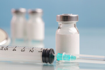 Close up image of vaccine or injection bottles with blank white label.  Vial bottle mockup. Science, vaccination, immunization, health care and medical concept. 
 