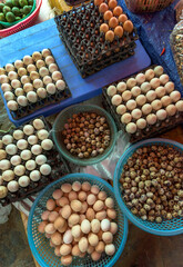 Top view on a assortment of loose eggs on a market, short circuit production