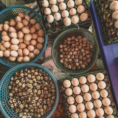 Top view on a assortment of loose eggs on a market, short circuit production