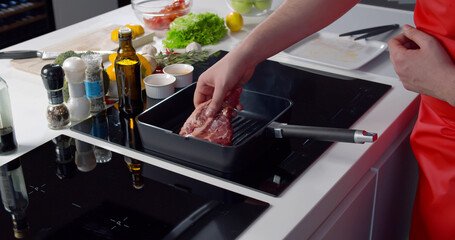 Close up of man chef pouring oil on hot grill frying pan cooking steak