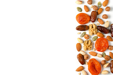 Nuts and dried fruits on a white background. Sources of antioxidants and vitamins. Healthy eating. Flat top view. Copy space